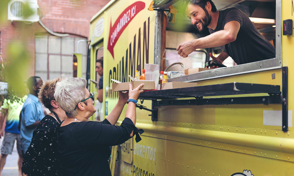 830553276 Woman making a payment at a foodtruck