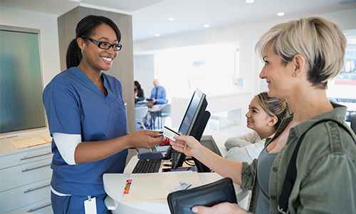 Healthcare worker taking a payment